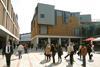 Pedestrians stroll between Panter Hudspith’s Debenhams, left, and a mixed-use pavilion.