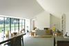 The living room looks on to the paddock through a wall of Crittall glazing.