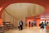 The library entrance is dominated by the sweeping spiral stairwell, lined with oak-veneered acoustic ribs.