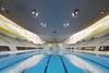 The roof meets the plinth structure behind the diving platforms.