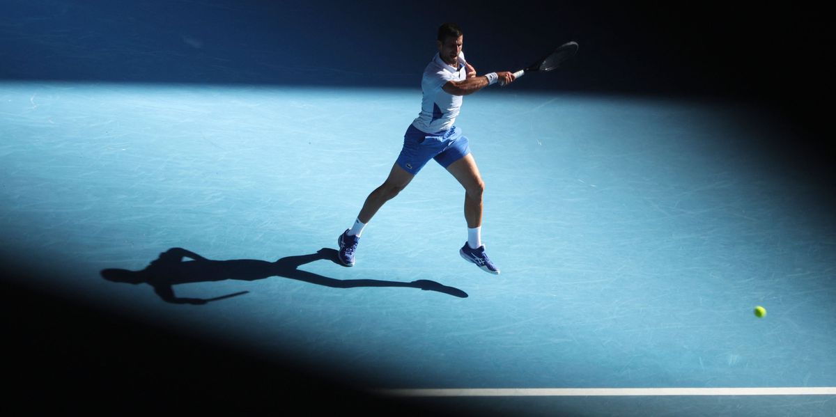 Serbia's Novak Djokovic hits a return against USA's Taylor Fritz during their men's singles quarter-final match on day 10 of the Australian Open tennis tournament in Melbourne on January 23, 2024. (Photo by Martin KEEP / AFP) / -- IMAGE RESTRICTED TO EDITORIAL USE - STRICTLY NO COMMERCIAL USE --