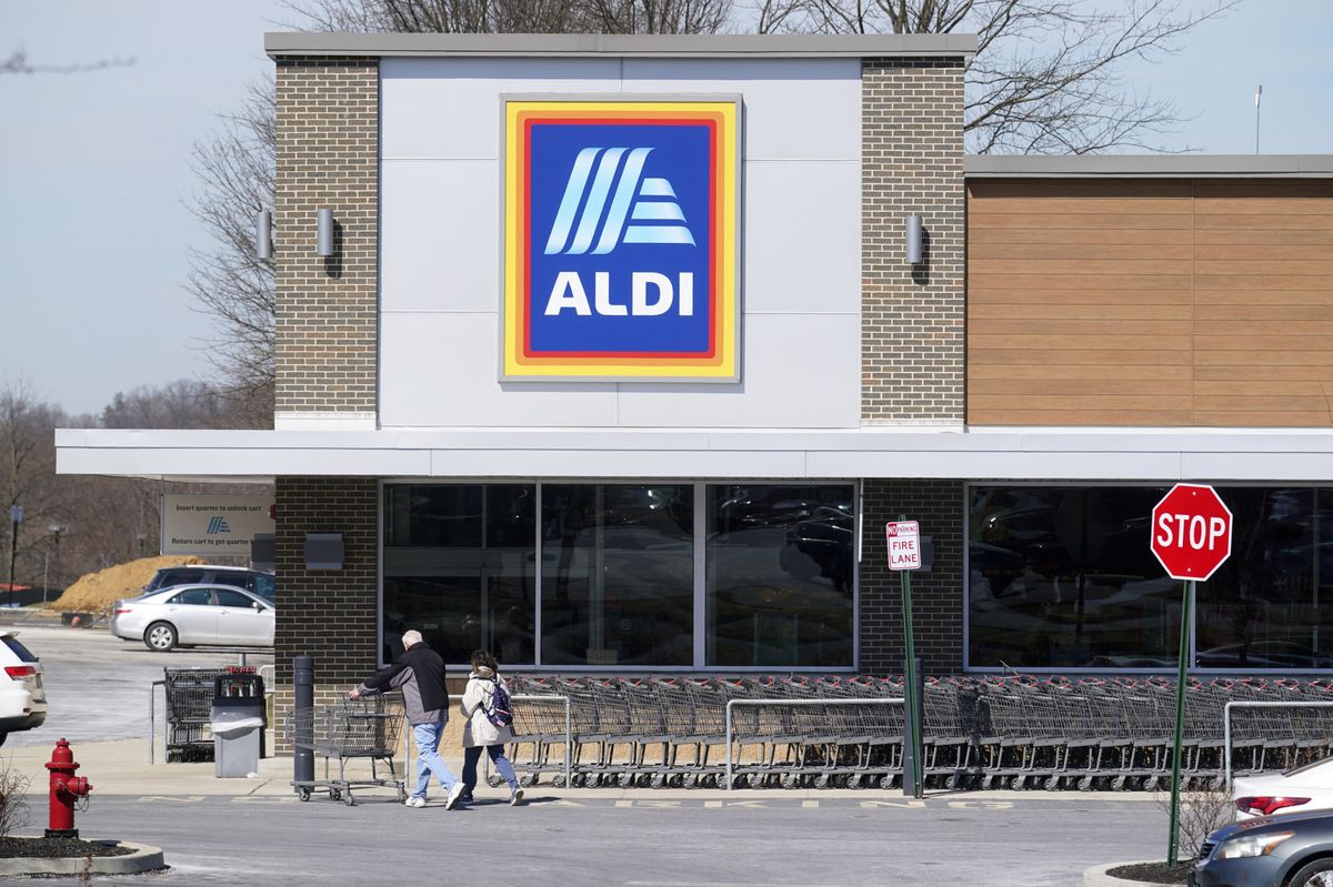 FILE - Customers walk into an Aldi supermarket in Bensalem, Pa., March 14, 2022. Discount grocer Aldi plans to add 800 stores across the U.S. in a five-year expansion plan as it looks to capitalize on cost-conscious Americans feeling the pinch at grocery stores. (AP Photo/Matt Rourke, File)