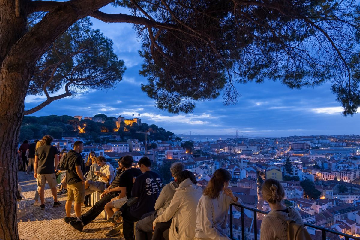 2WA5MKG Lisbon, Portugal - October 15, 2023 - People relax at Miradouro da Graca viewpoint in the evening, view of the capital city from a hill.