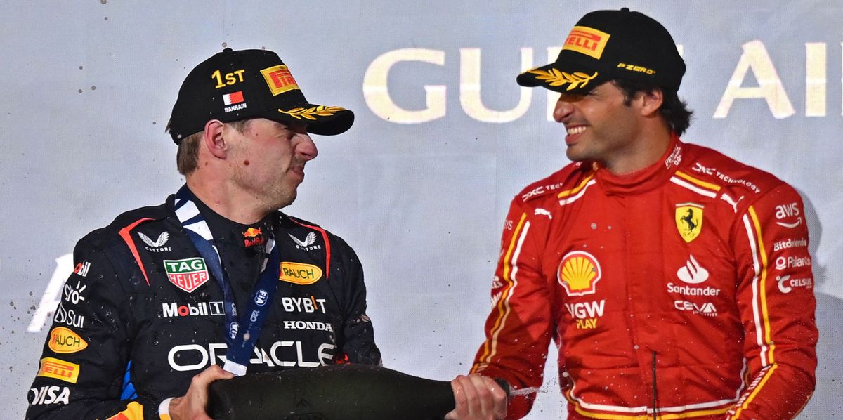 First placed Red Bull Racing's Dutch driver Max Verstappen (L) and third placed Ferrari's Spanish driver Carlos Sainz Jr celebrate during the podium ceremony of the Bahrain Formula One Grand Prix at the Bahrain International Circuit in Sakhir on March 2, 2024. (Photo by ANDREJ ISAKOVIC / AFP)