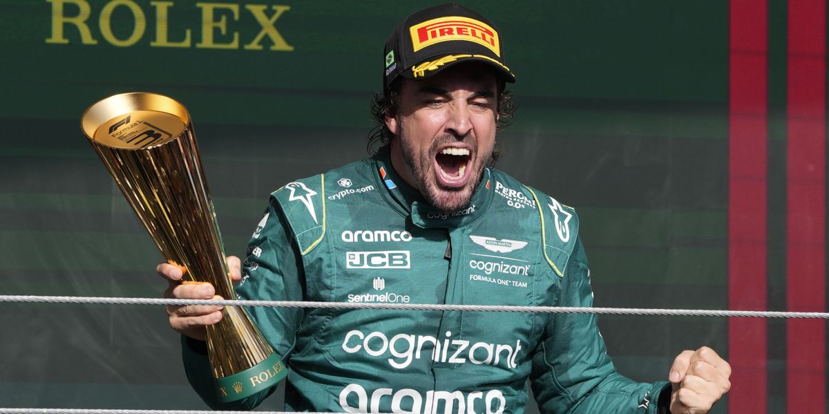 Aston Martin driver Fernando Alonso of Spain celebrates his third-place finish, on the podium at the end of the Brazilian Formula One Grand Prix at the Interlagos race track in Sao Paulo, Brazil, Sunday, Nov. 5, 2023. (AP Photo/Andre Penner)
