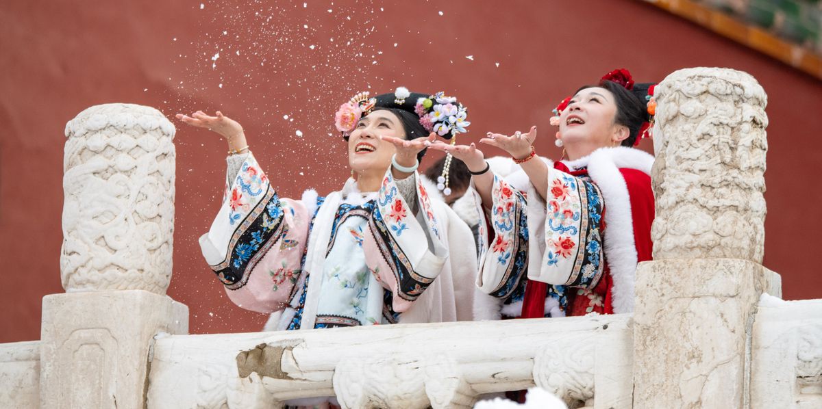 BEIJING, CHINA - FEBRUARY 21: Tourists in ancient costumes play with snow at the Palace Museum after a snowfall on February 21, 2024 in Beijing, China. Beijing welcomed the first snow of the Year of the Dragon on February 20. (Photo by Chen Boyuan/VCG via Getty Images)