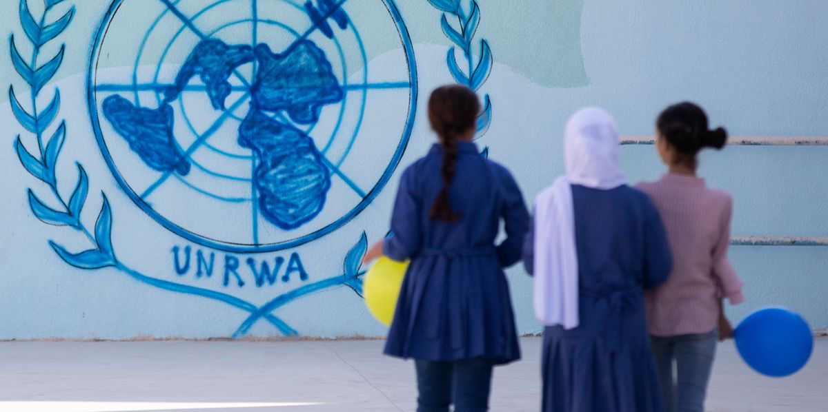 epa07809796 Students walk past a drawing depicting the sign of the United Nations Relief and Works Agency for Palestine Refugees in the Near East (UNRWA) at Nuzha Girls School, in Amman, Jordan, 01 September 2019. The Commissioner-General of the UNRWA Pierre Krahenbuhl visited the school during the first day of Back to School activities at UNRWA schools in Jordan.  EPA/ANDRE PAIN