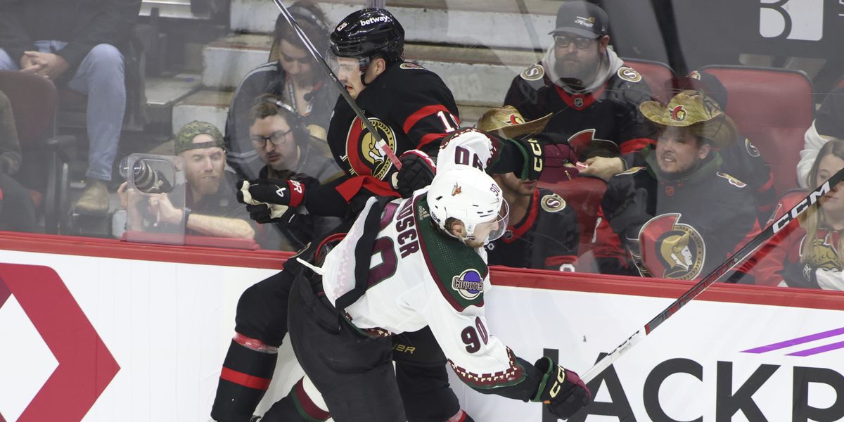 Ottawa Senators' Drake Batherson (19) and Arizona Coyotes' J.J. Moser (90) collide during the third period of an NHL hockey game in Ottawa, Ontario on Friday, March 1, 2024. (Patrick Doyle/The Canadian Press via AP)