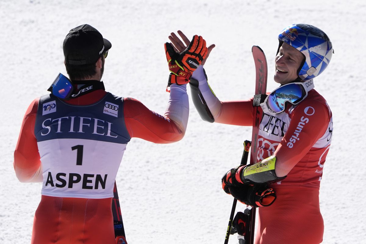 Switzerland's Marco Odermatt, right, celebrates after his victory with second-place finisher, compatriot Loic Meillard, after a men's World Cup giant slalom skiing race, Friday, March 1, 2024, in Aspen, Colo. (AP Photo/Robert F. Bukaty)